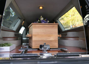 closeup shot of a colorful casket in a hearse or chapel before funeral or burial at cemetery